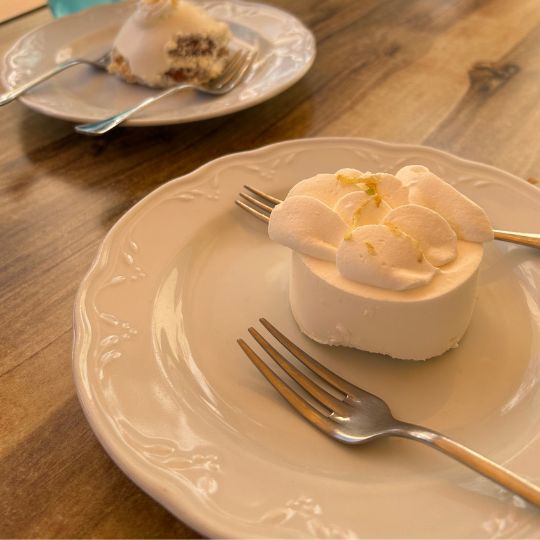 Individual lemon dessert topped with whipped cream on a white plate at a restaurant on Italy's Amalfi Coast.