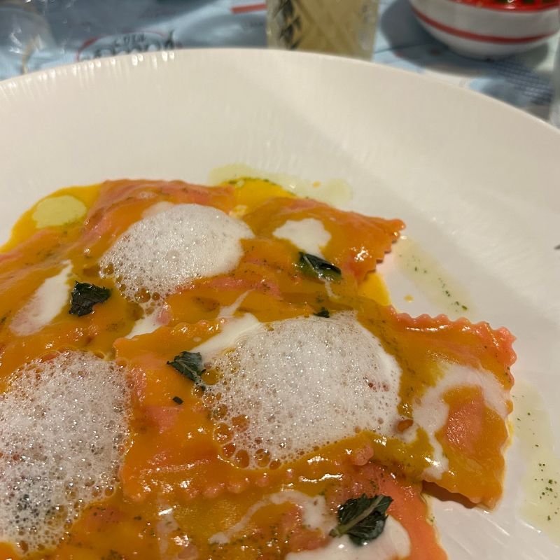 Plate of ravioli topped with a creamy sauce and herbs, served at a restaurant on Italy's Amalfi Coast.