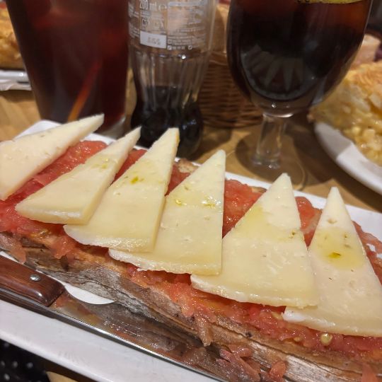 Spanish toast topped with tomato and Manchego cheese