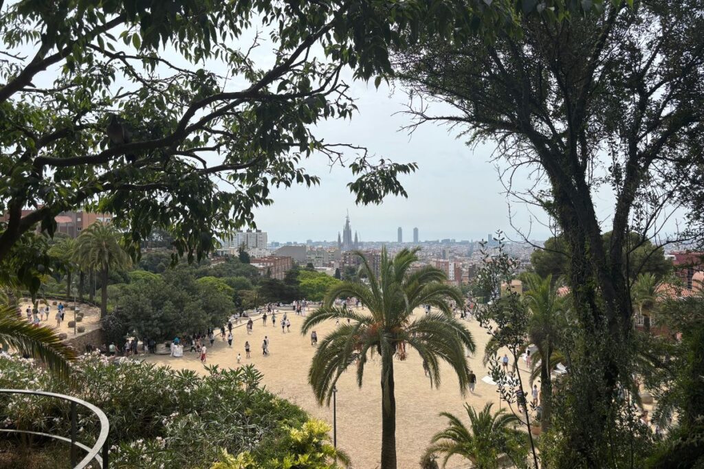 View across Park Güell toward the Barcelona skyline and Sagrada Família