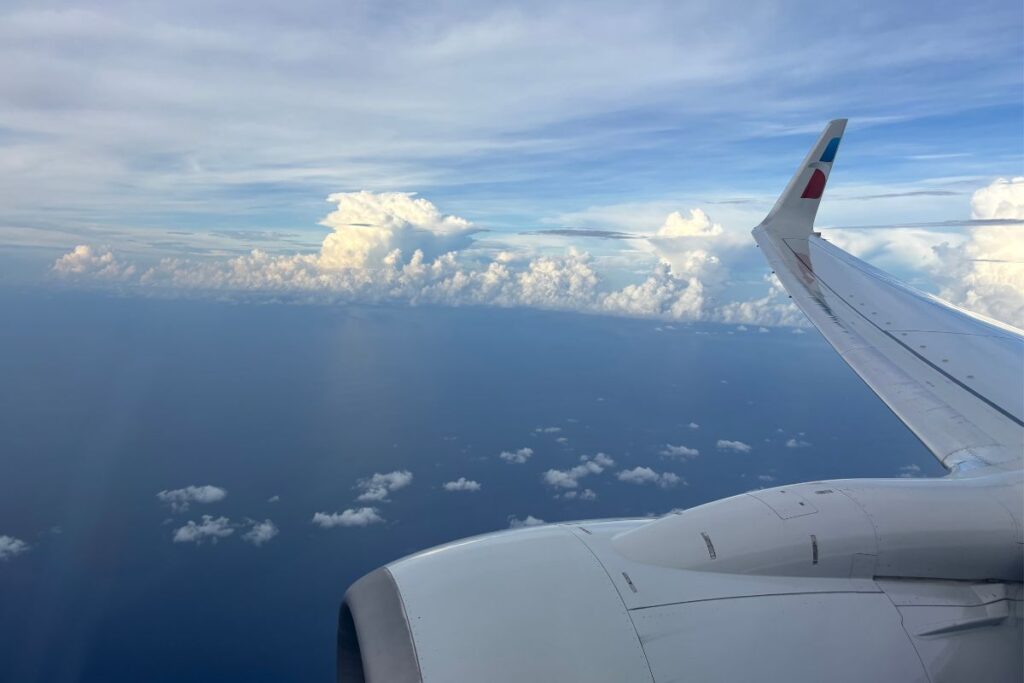 Airplane wing viewed above the clouds during a flight