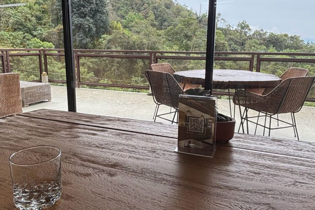 Outdoor terrace at Cannúa near Guatapé, Colombia, overlooking the surrounding forested mountains and countryside.