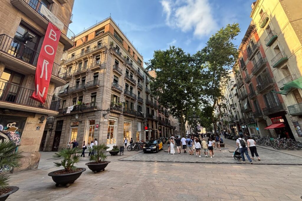 Pedestrian street lined with shops and historic buildings in Barcelona's El Born neighborhood