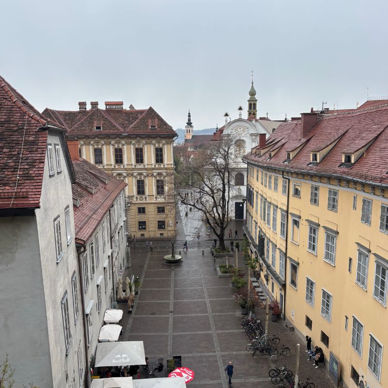 View over a quiet street and historic buildings from Schlossberg Hill in Graz