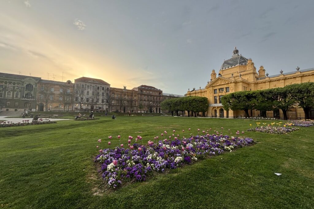 Golden hour view of a park and historic architecture in central Zagreb, Croatia.