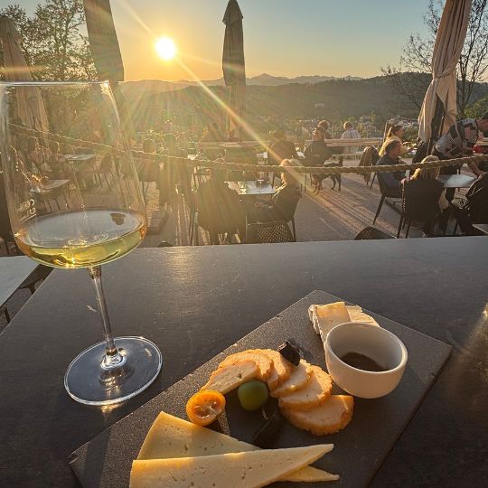 Wine and local cheeses enjoyed at sunset overlooking the Slovenian countryside