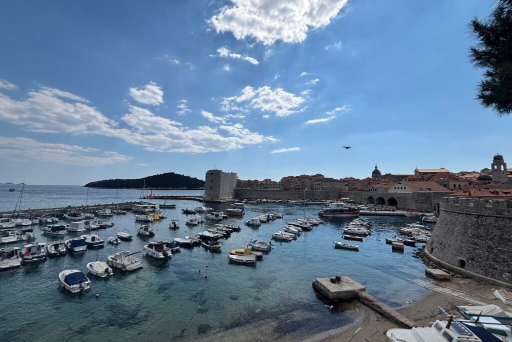 Dubrovnik Old Harbor, city walls, and Lokrum Island viewed from the medieval walls in Dubrovnik, Croatia