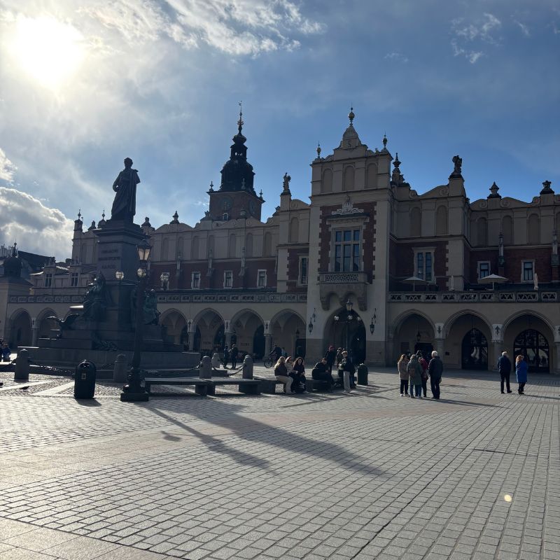 Kraków's Main Market Square with the Cloth Hall and Town Hall Tower in the background.