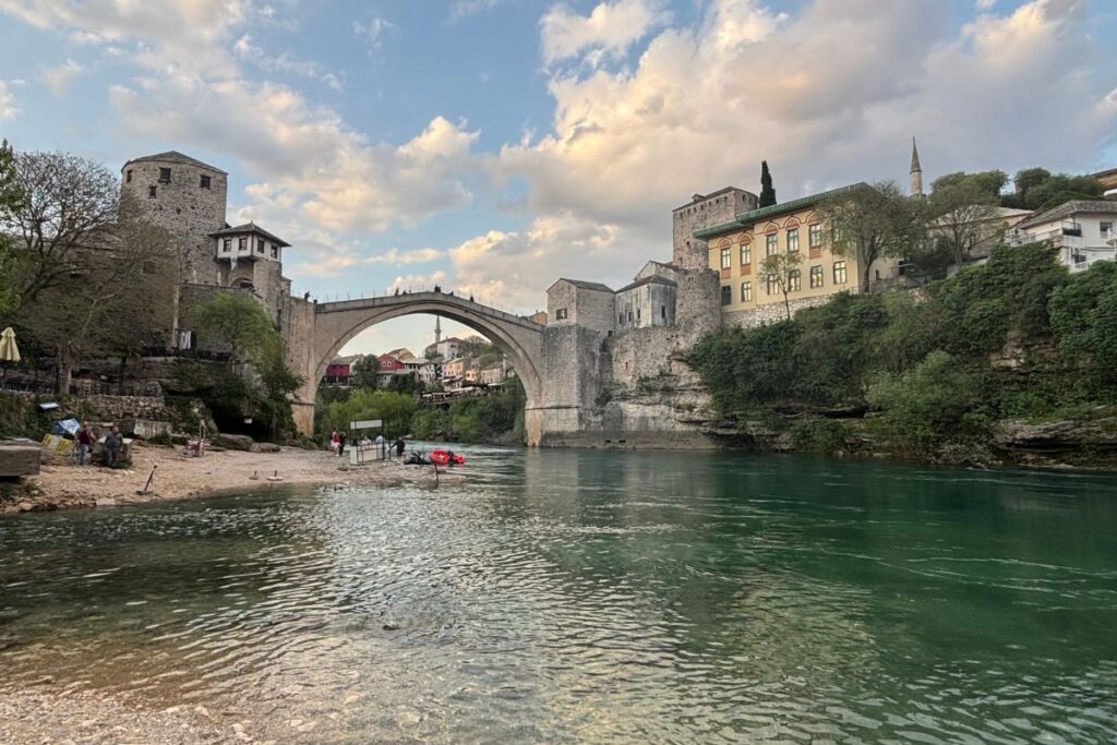 Stari Most bridge reflected in the Neretva River at sunset in Mostar, Bosnia and Herzegovina.