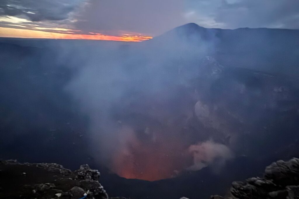 Glowing lava inside the active crater of Masaya Volcano at dusk during a nighttime visit from Granada, Nicaragua.