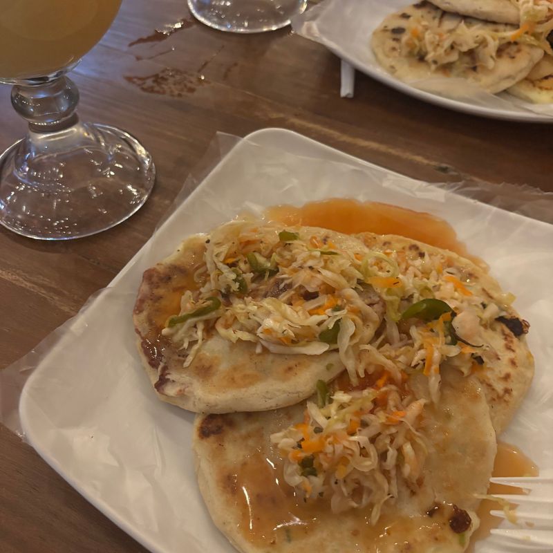 Traditional Salvadoran pupusas served with curtido and tomato salsa at a local restaurant in Santa Ana, El Salvador.