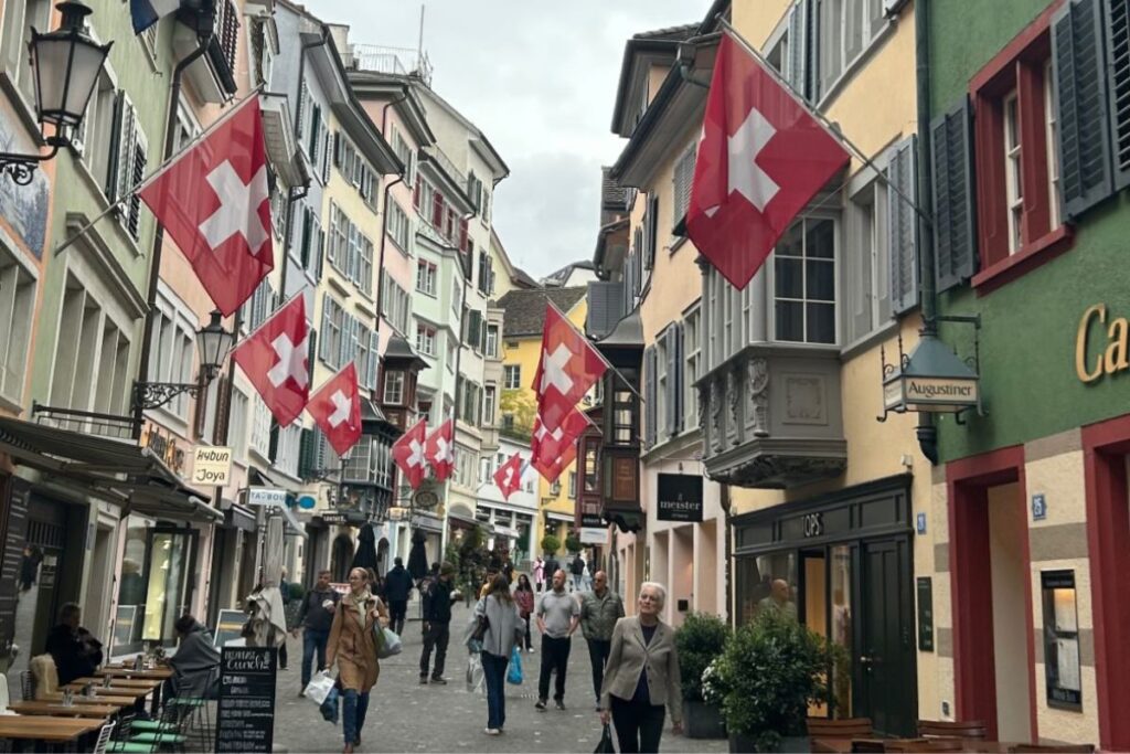 Swiss flags hanging above a pedestrian street in Zurich, Switzerland