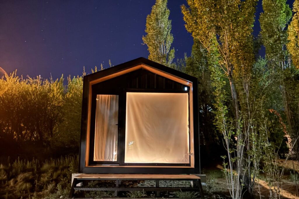 Modern cabin surrounded by trees at night in El Calafate, Patagonia, Argentina.