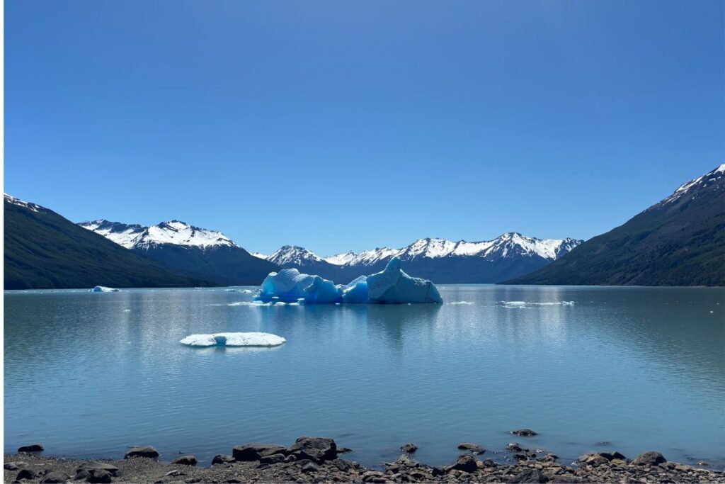 Icebergs floating on Lago Argentino surrounded by snow-capped mountains in Patagonia, Argentina