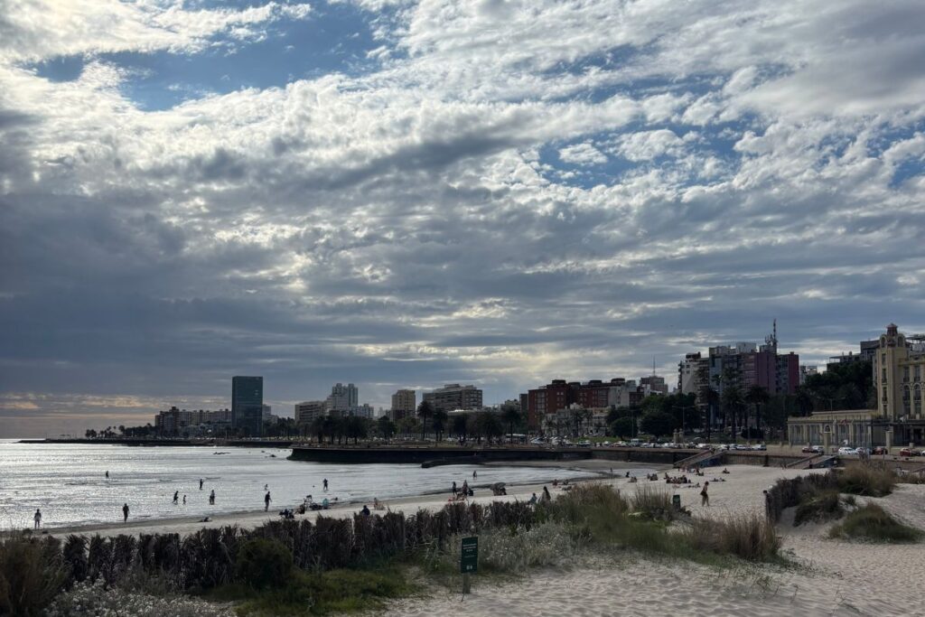 View of Montevideo's waterfront and Playa Ramírez beach under a dramatic cloudy sky in Uruguay.