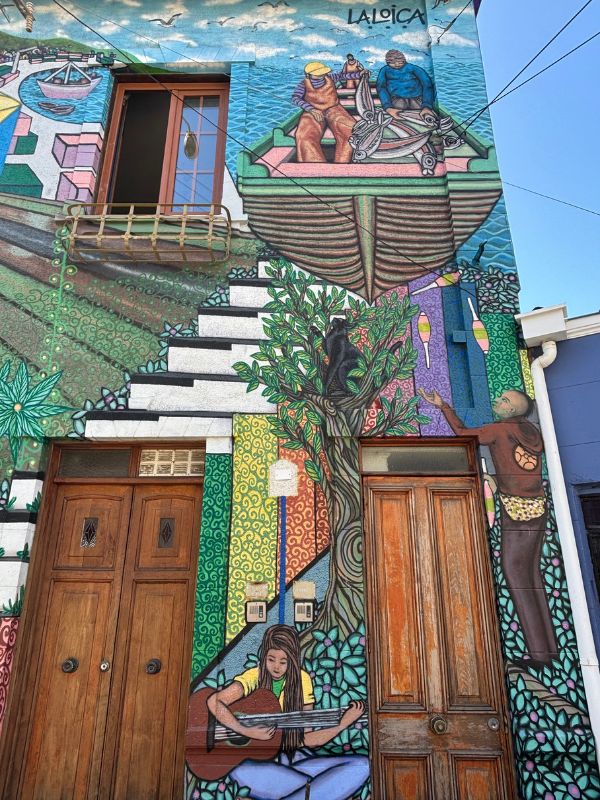 Colorful street mural decorating a building in Valparaíso, Chile.
