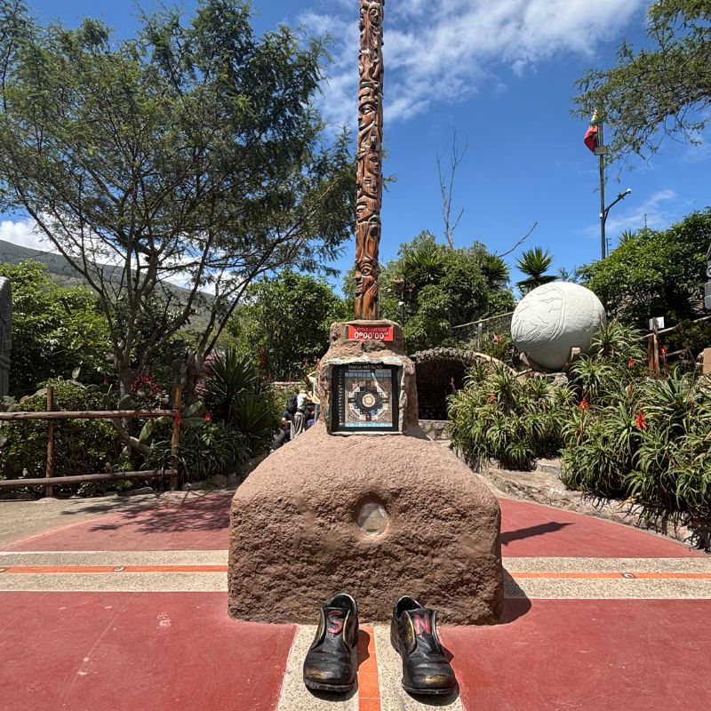 Equator marker at the Mitad del Mundo complex near Quito, Ecuador, with the marked equator line and monument in the background.