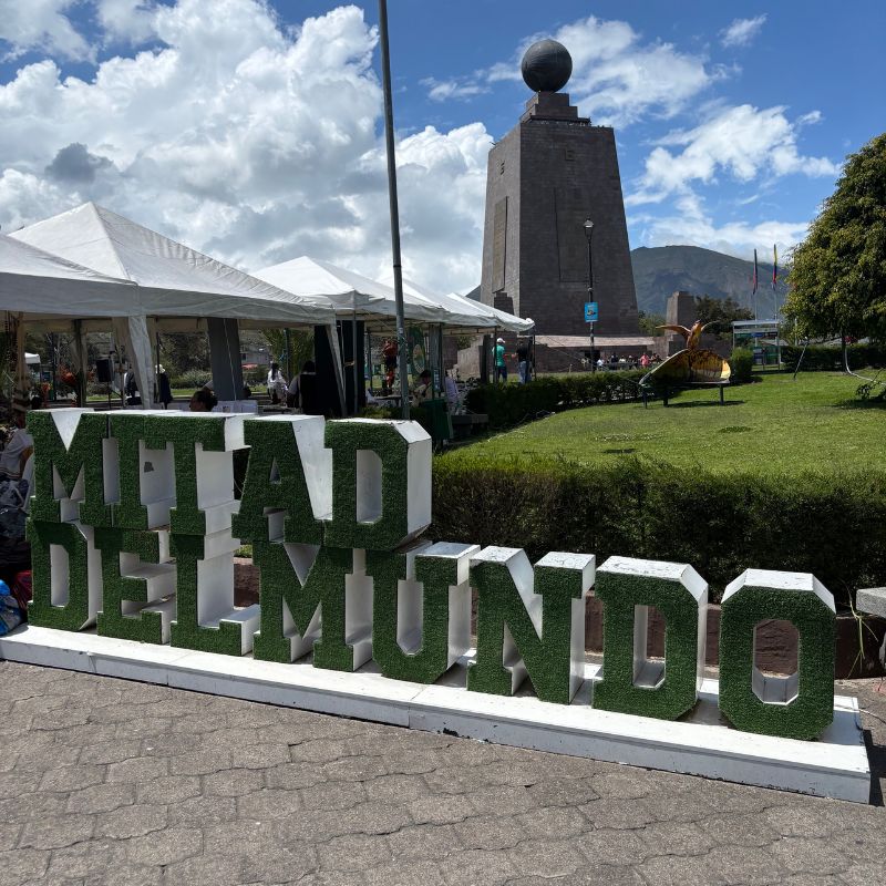 Mitad del Mundo monument and "Mitad del Mundo" sign at the Middle of the World complex near Quito, Ecuador.