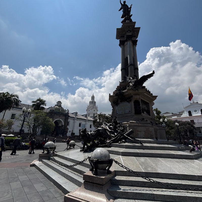 Independence Monument in Plaza Grande surrounded by historic buildings in Quito's UNESCO-listed Historic Center.
