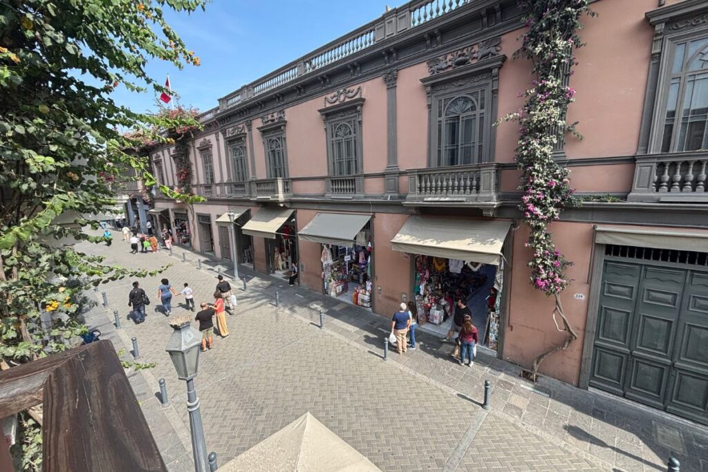 Pedestrian street lined with historic buildings and shops in central Lima
